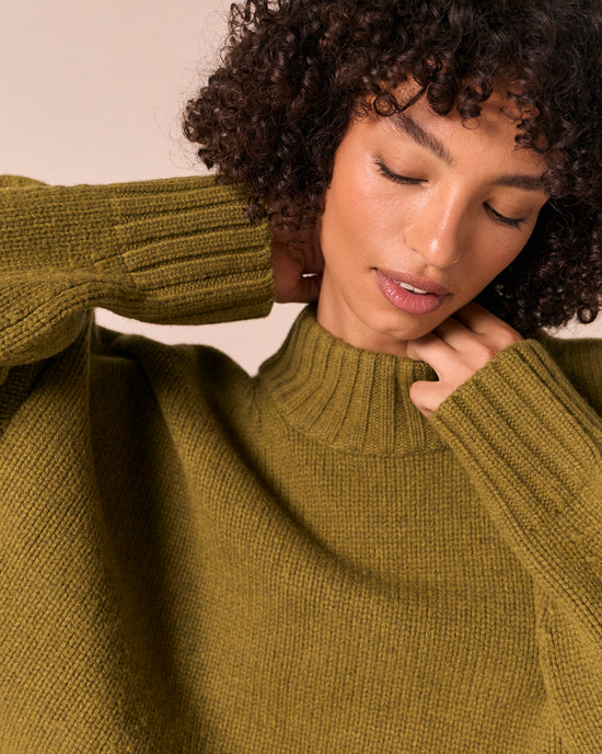 model wears kimi moss green knitted jumper