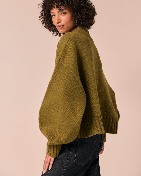 model wears kimi moss green knitted jumper