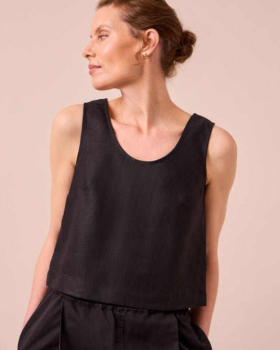 model wears kim black linen top