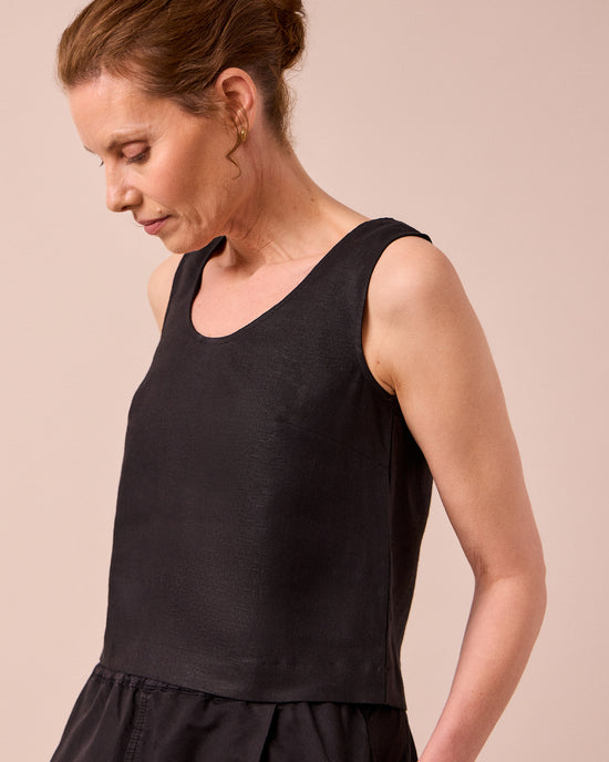 model wears kim black linen top