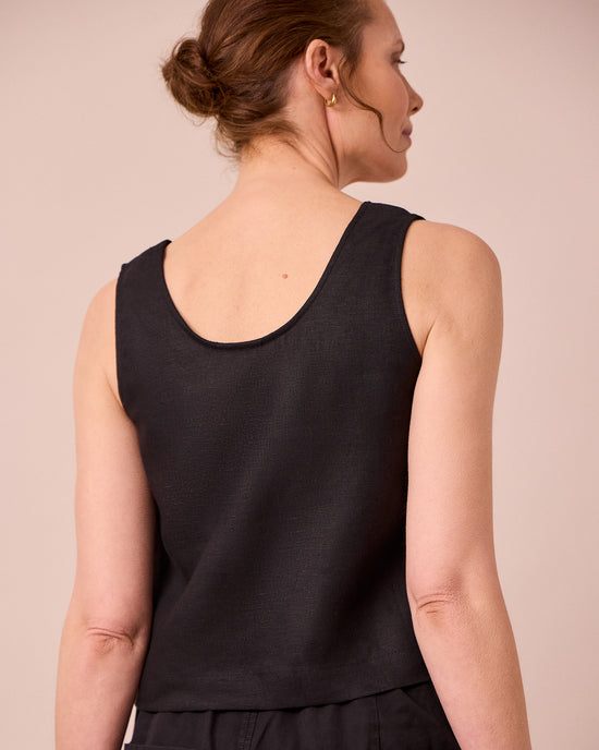 model wears kim black linen top