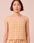 model wears kim ochre gingham linen top