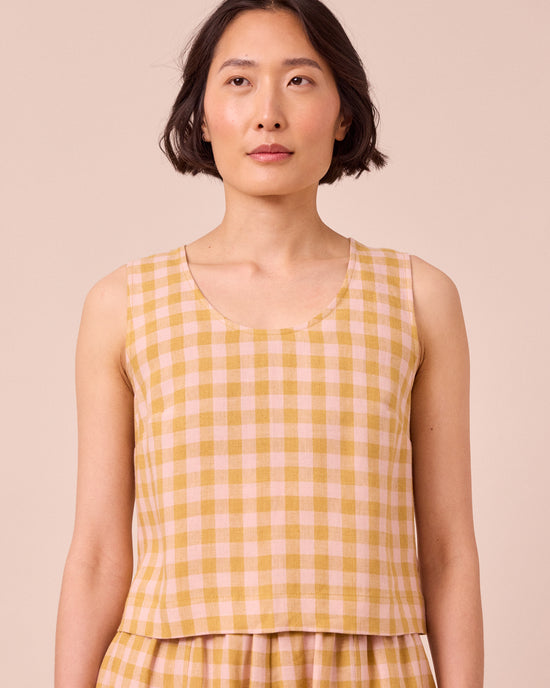 model wears kim ochre gingham linen top