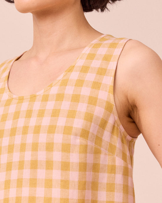 model wears kim ochre gingham linen top