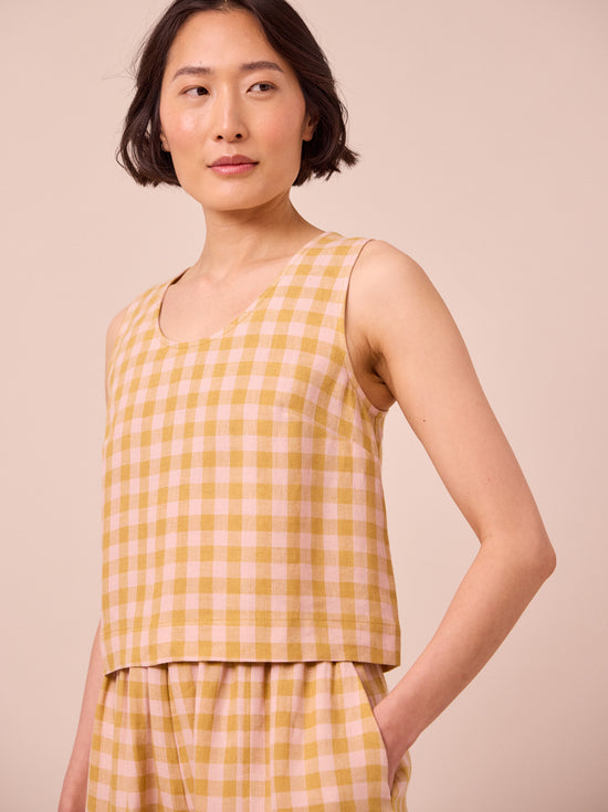 model wears kim ochre gingham linen top