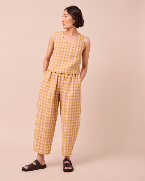 model wears kim ochre gingham linen top