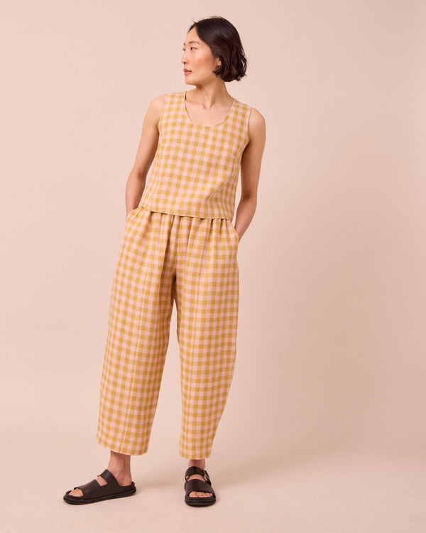 model wears kim ochre gingham linen top