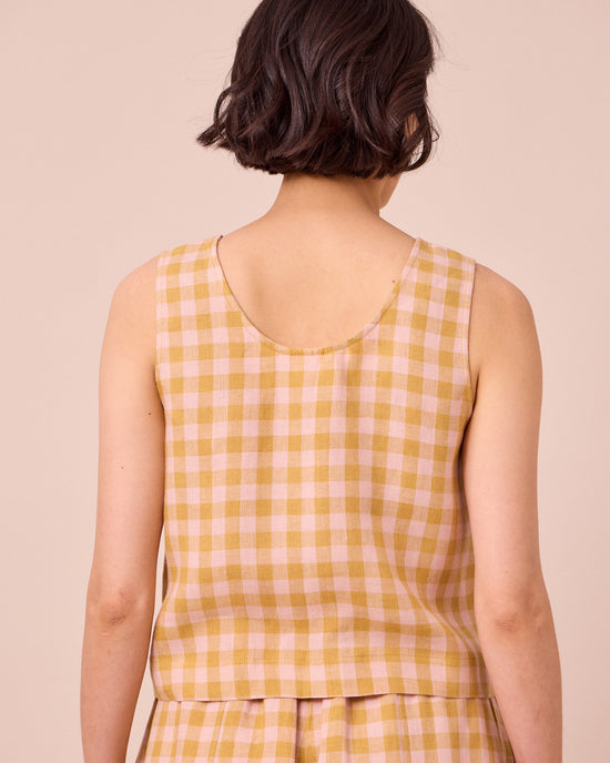 model wears kim ochre gingham linen top
