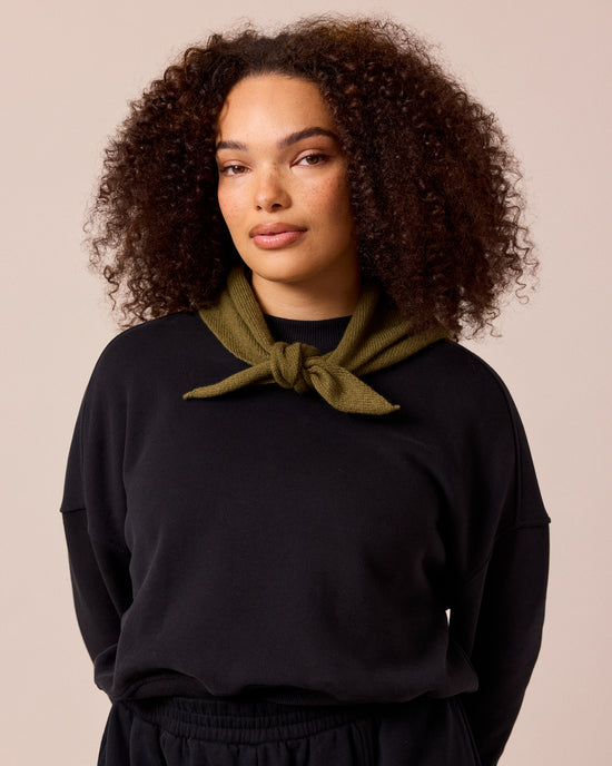 model wears olive knitted neckerchief