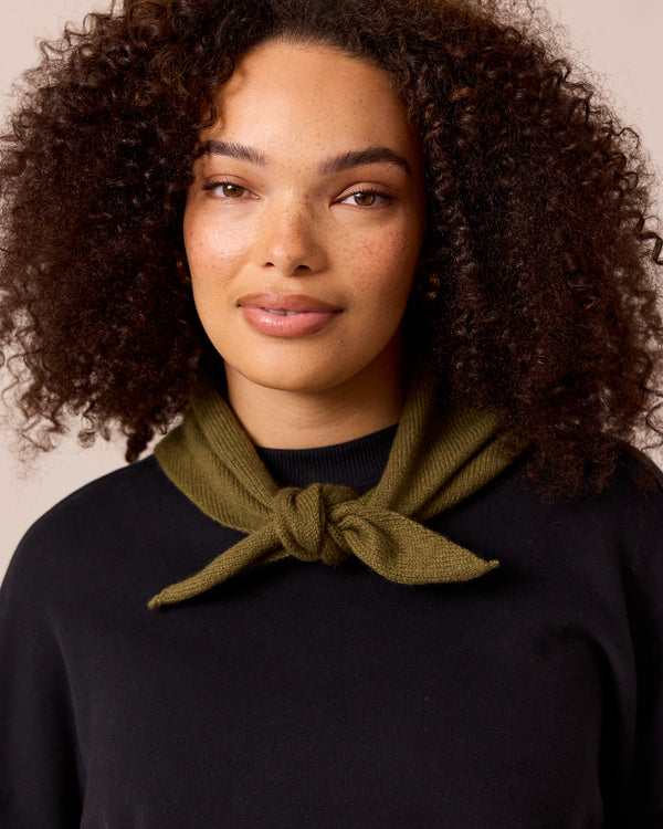 model wears olive knitted neckerchief