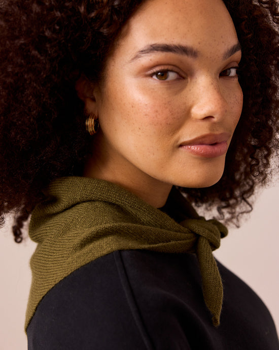 model wears olive knitted neckerchief