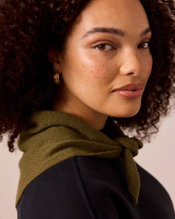 model wears olive knitted neckerchief
