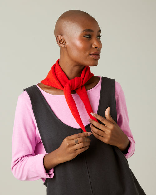 model wears knitted chilli red neckerchief