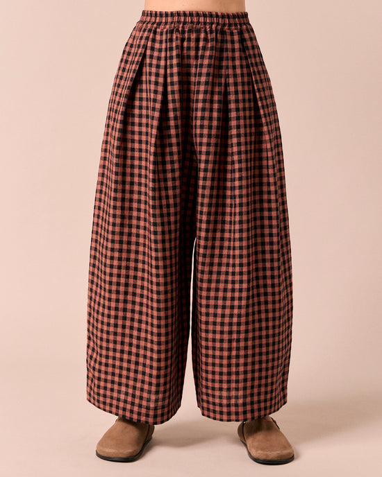 model wears layne dried rose gingham linen trousers front