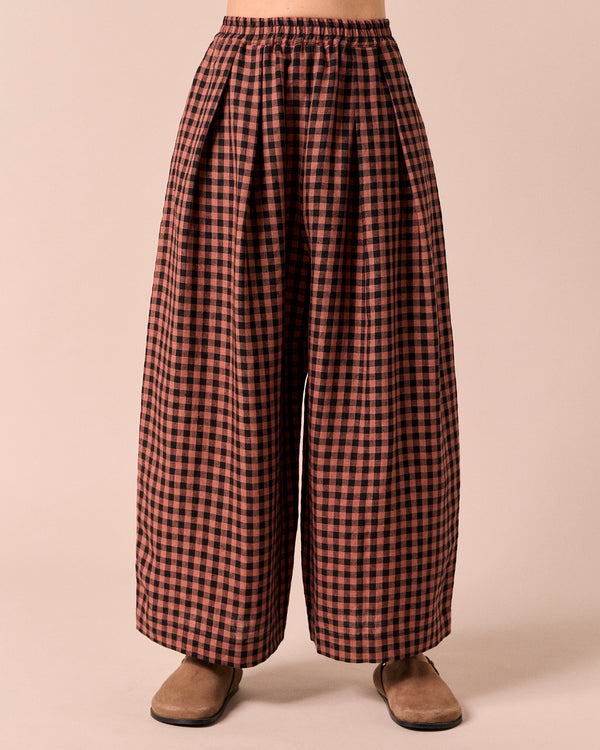 model wears layne dried rose gingham linen trousers front