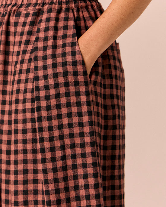 model wears layne dried rose gingham linen trousers 