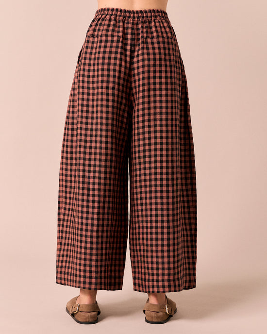 model wears layne dried rose gingham linen trousers back