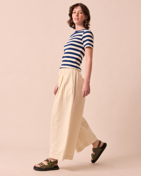 model wears layne bone cotton linen trousers left