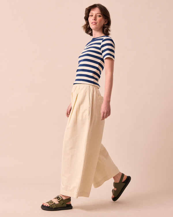 model wears layne bone cotton linen trousers left