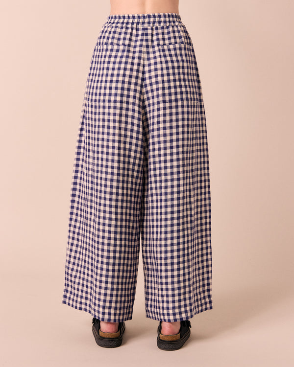 model wears linen indigo gingham layne trousers 