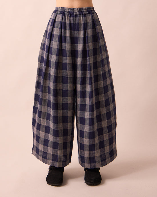 model wears layne navy plaid linen trousers front
