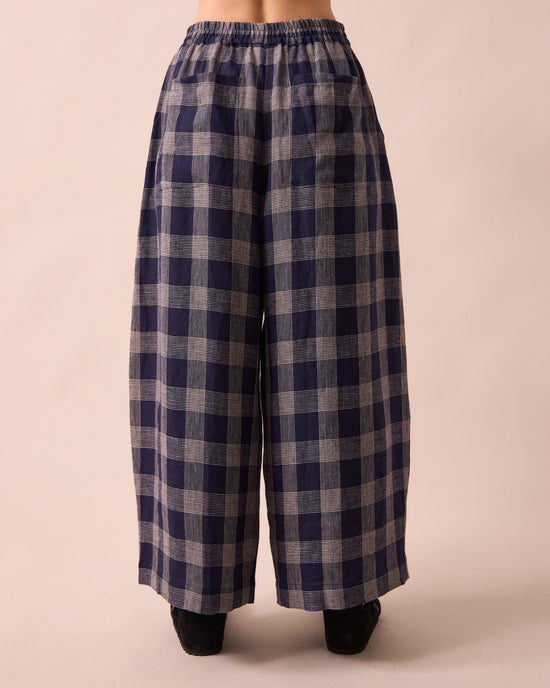 model wears layne navy plaid linen trousers back
