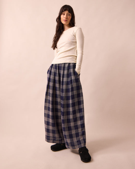 model wears layne navy plaid linen trousers left