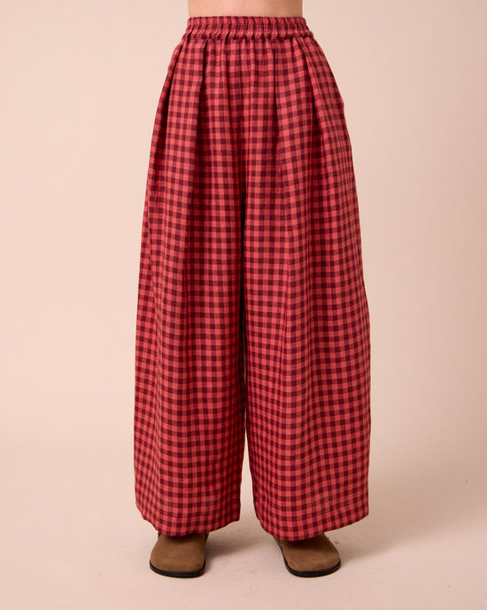 model wears layne deep rose gingham linen trousers front