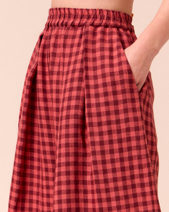 model wears layne deep rose gingham linen trousers