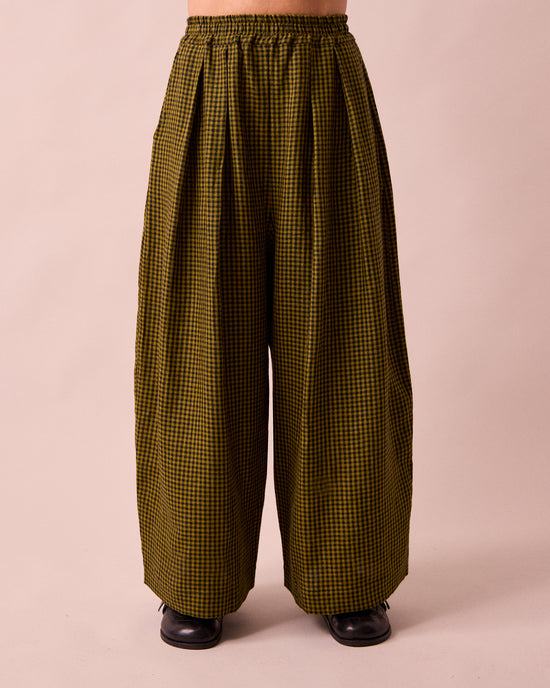 model wears layne fresh olive mini gingham linen trousers front