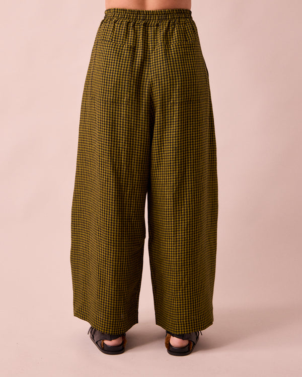 model wears layne fresh olive mini gingham linen trousers back