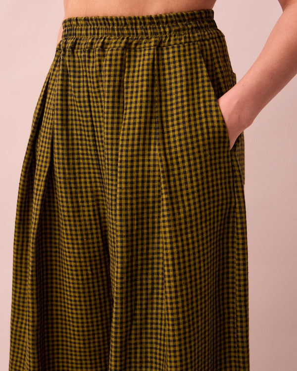 model wears layne fresh olive mini gingham linen trousers