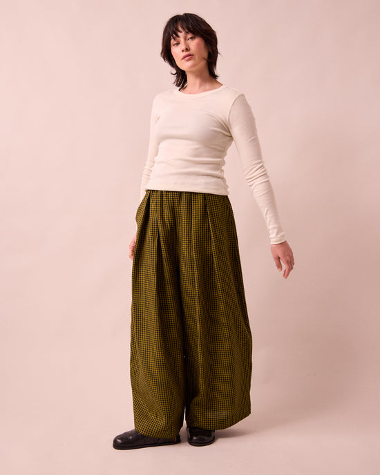 model wears layne fresh olive mini gingham linen trousers right