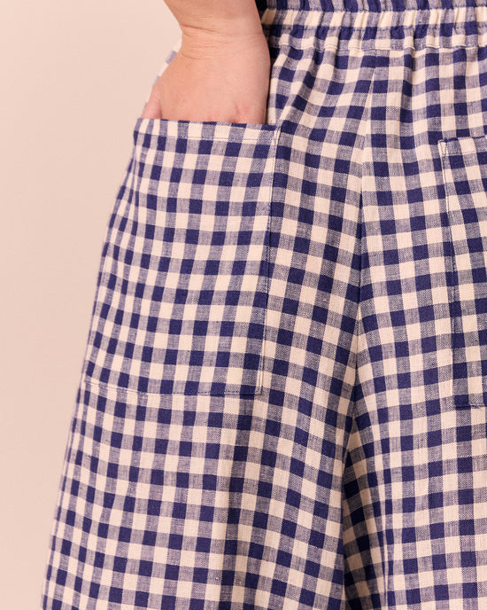 model wears linen indigo gingham layne trousers 