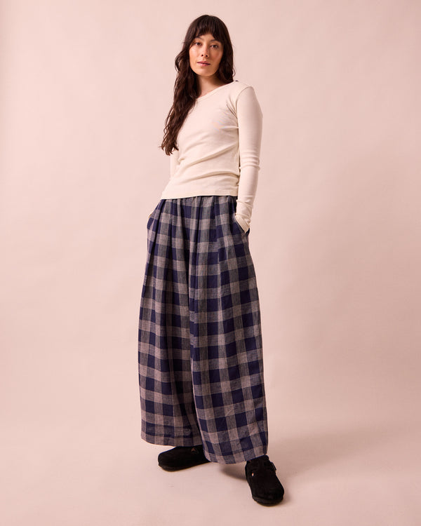 model wears layne navy plaid linen trousers left