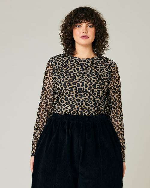 model wears leopard print mesh top