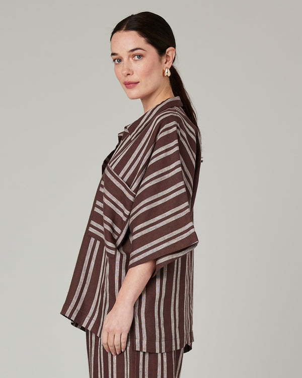 model wears coconut stripe cara linen shirt