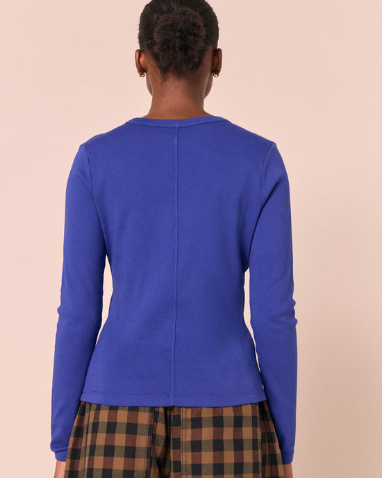 model wears lila klein blue jersey top