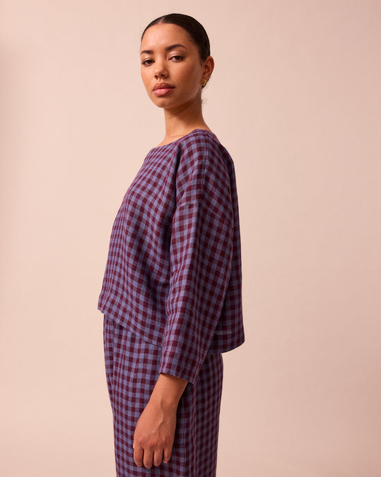model wears lily blueberry gingham linen top left