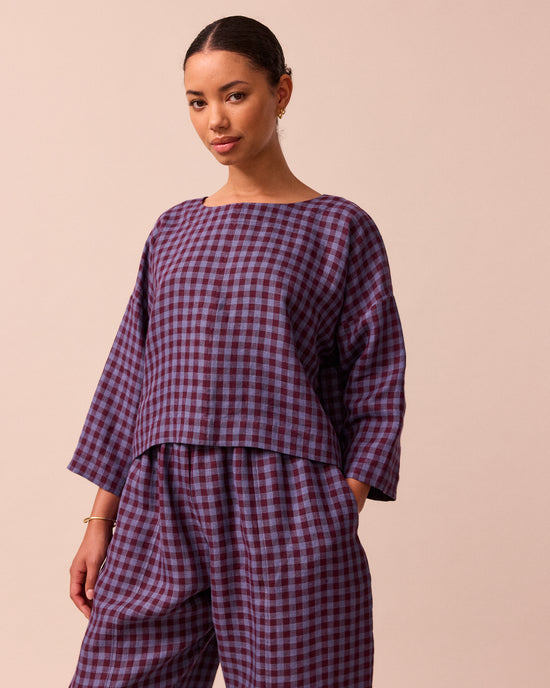 model wears lily blueberry gingham linen top left