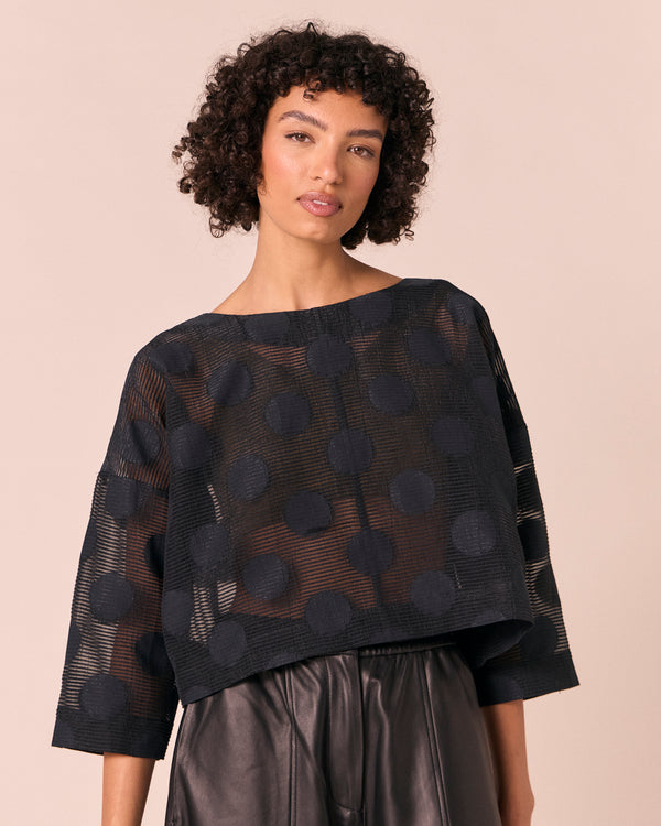 model wears lily black sheer spot top