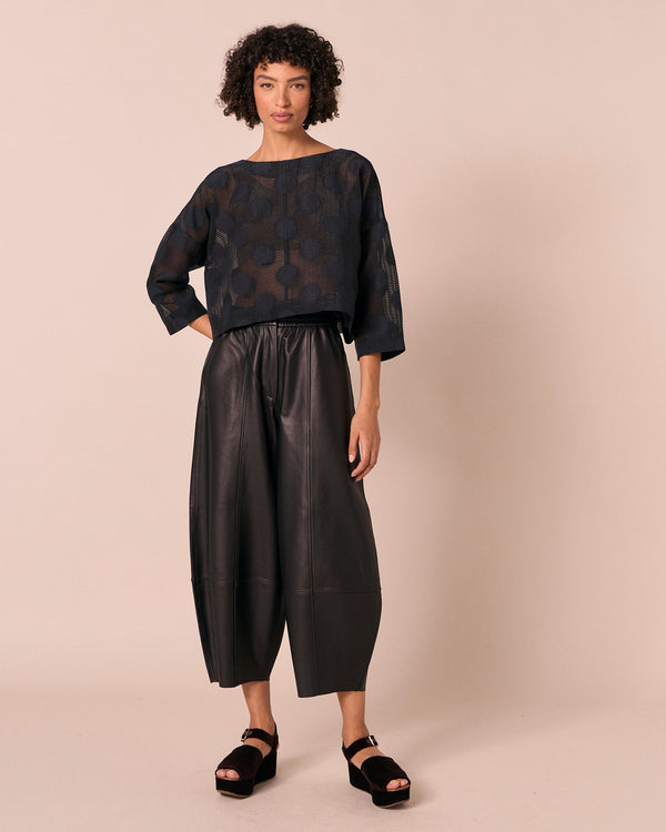 model wears lily black sheer spot top
