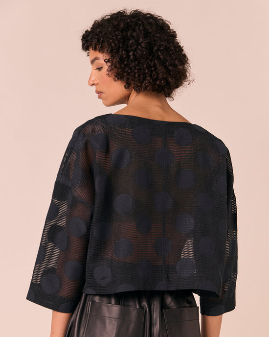 model wears lily black sheer spot top