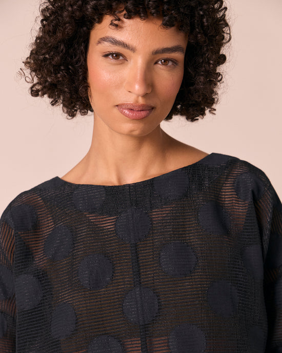 model wears lily black sheer spot top