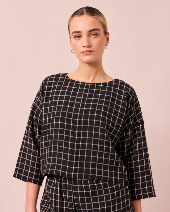 model wears lily black grid linen top