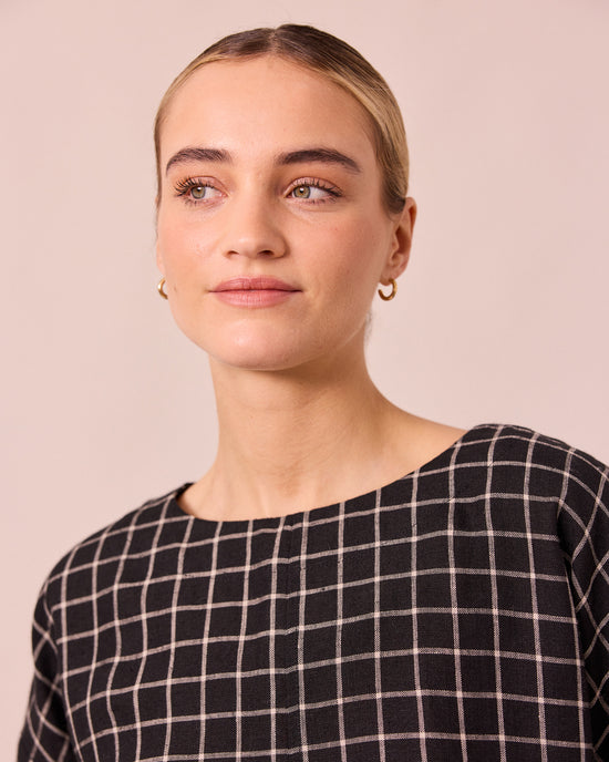 model wears lily black grid linen top