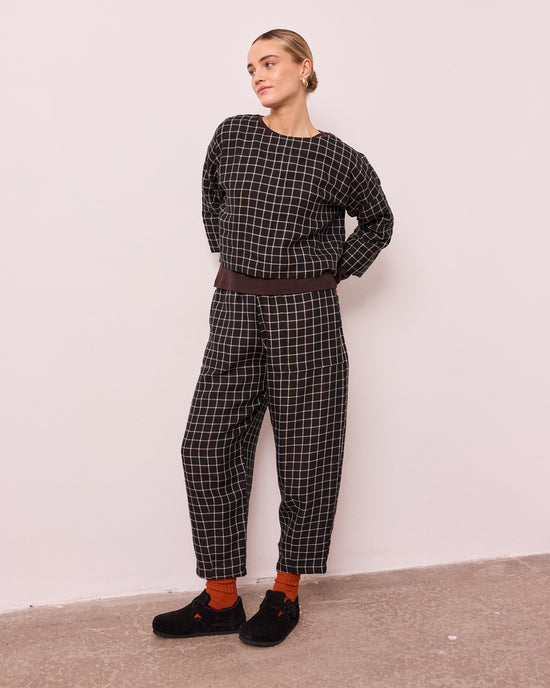 model wears huxley black grid linen trousers