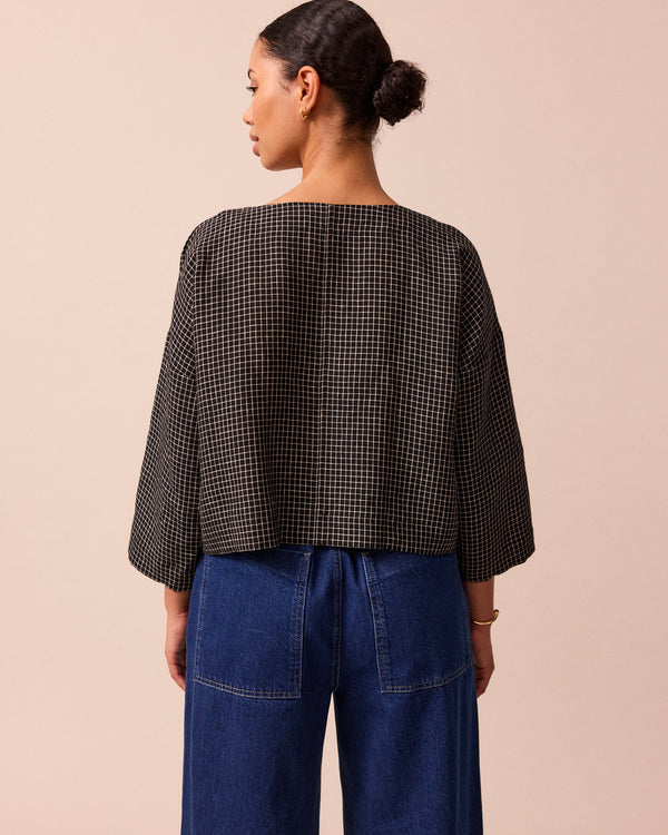 model wears lily black mini grid linen top