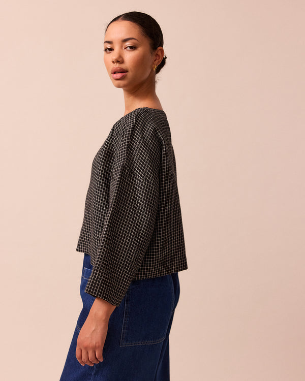 model wears lily black mini grid linen top
