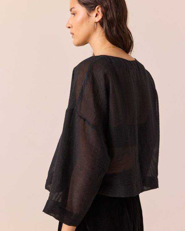 model wears lily black sheer stripe top